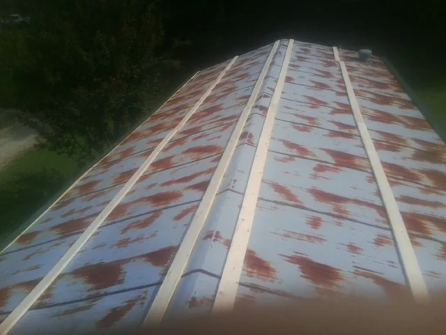 Rusted metal roof panels with new wood purlins before replacement — Storm Damage Roof Repair in West Lafayette by Roofing Brothers