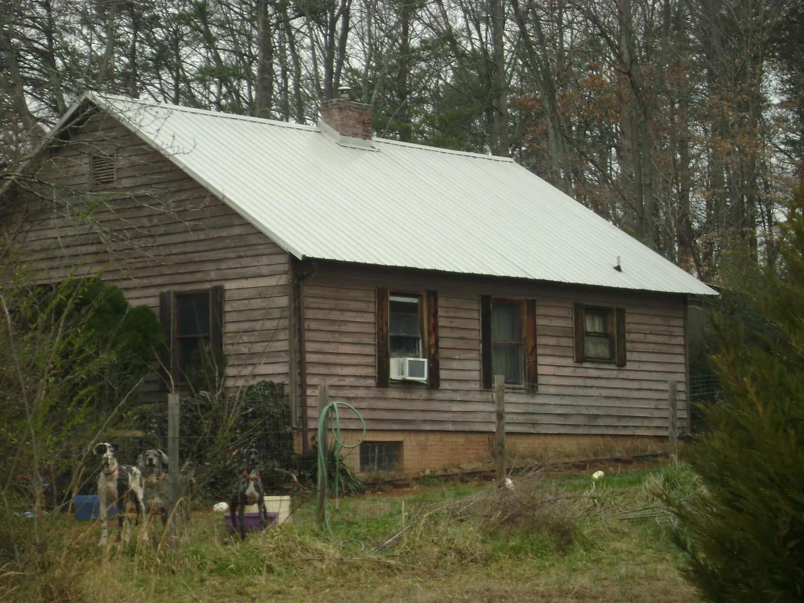 White metal roof on an old wood sided farmhouse, from a Metal Roof Installation job in West Lafayette